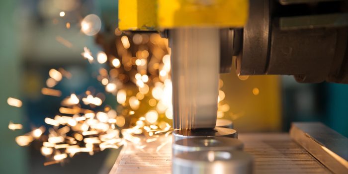 metalworking industry: finishing metal working on horizontal surface grinder machine with flying sparks