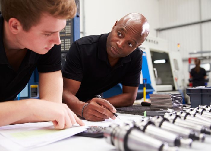Engineer And Apprentice Planning CNC Machinery Project